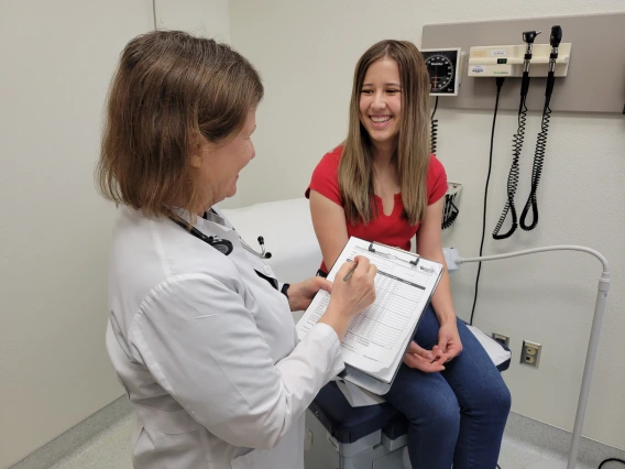 doctor and patient in room together smiling