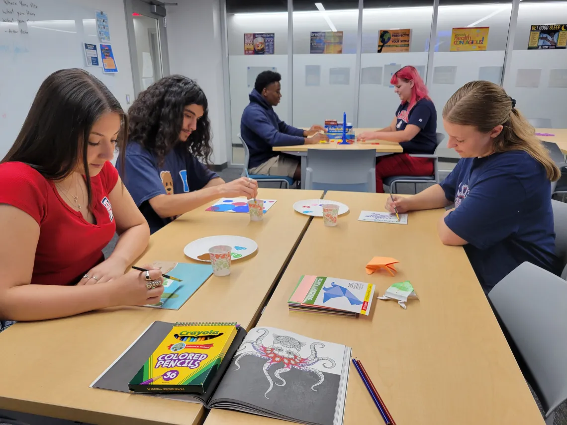 Students painting and playing connect 4.