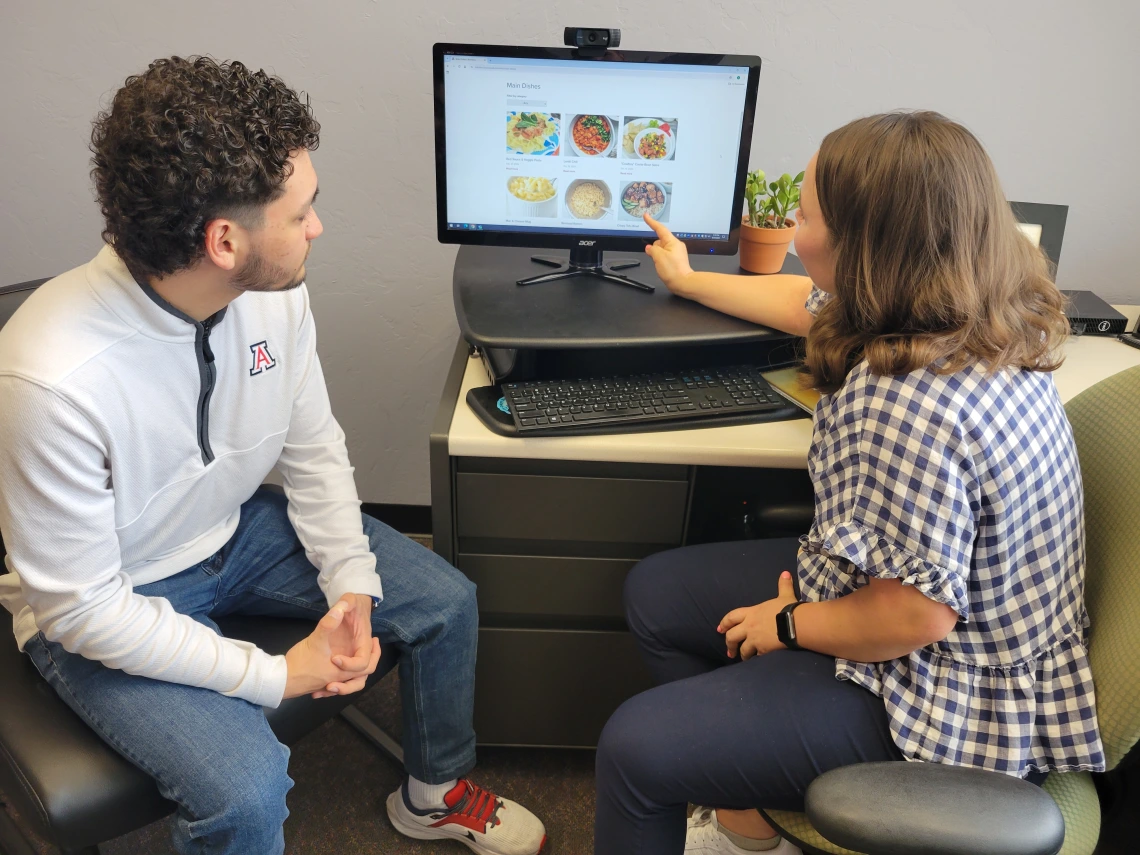 Student and Dietitian looking at recipes on a computer together
