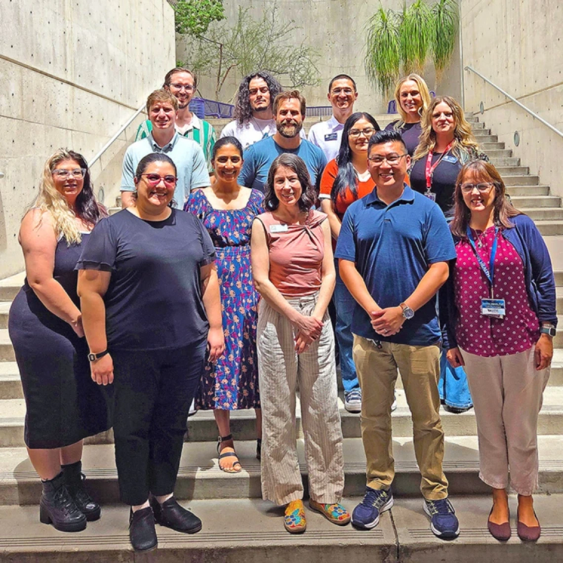 group of staff members standing in an outdoor stairwell