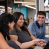 3 students sitting together smiling and talking